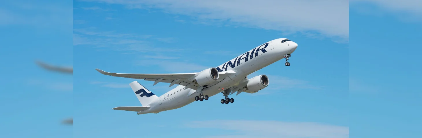 Image of a Finnair plane flying through the air