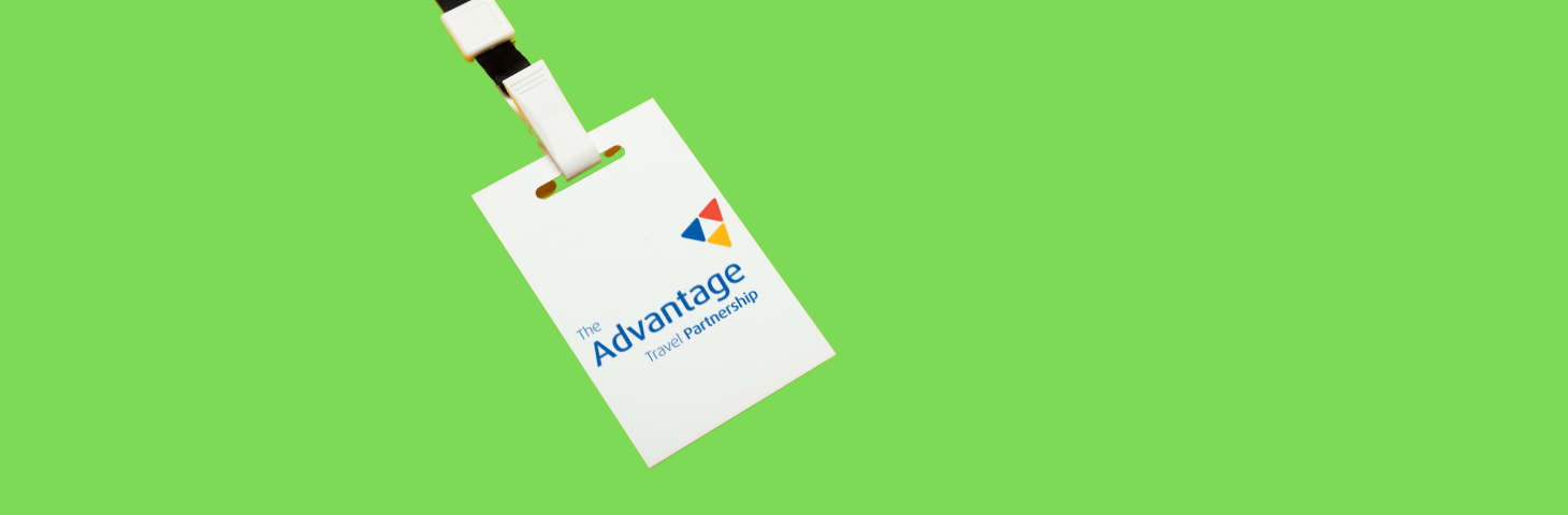 A lanyard with the Advantage Travel Partnership logo on a green background.