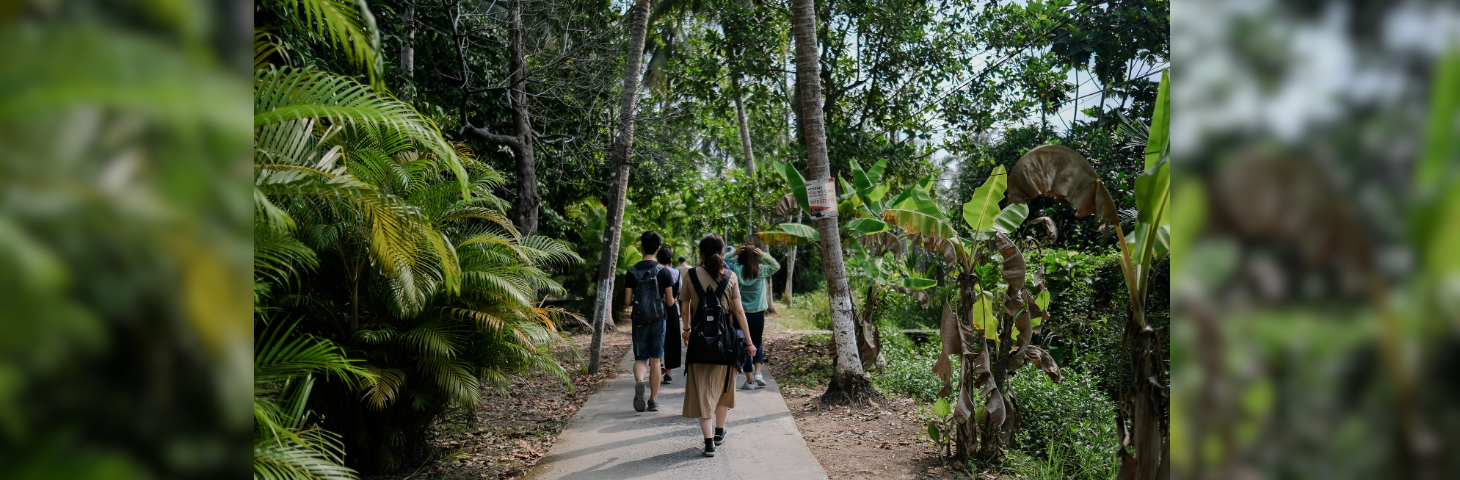 Young travellers walking through a planted area in a hotel.