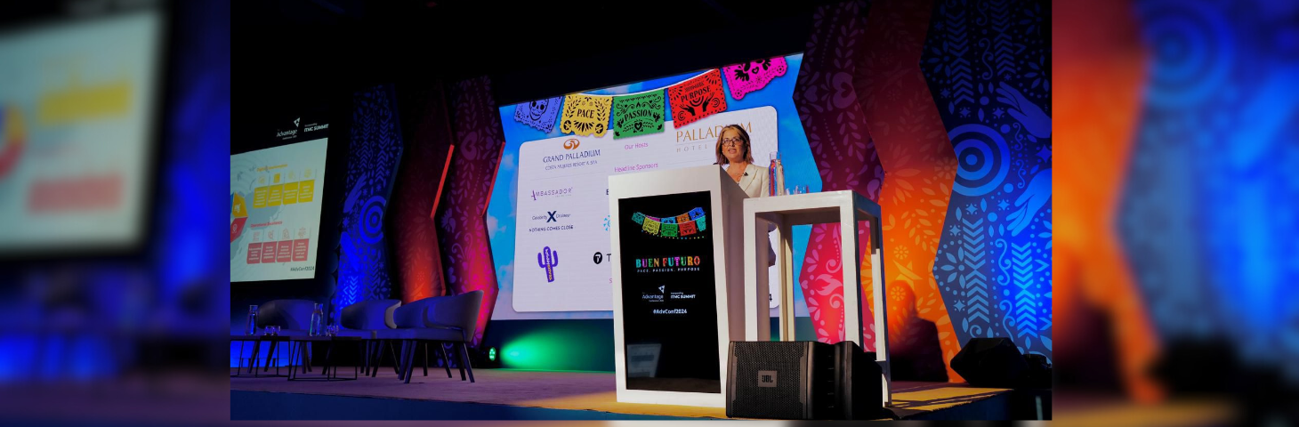 Julia Lo Bue-Said delivering an opening keynote speech on stage at the Advantage Travel Partnership Conference 2024.