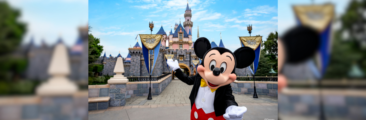 Mickey Mouse welcoming guests to Sleeping Beauty castle at Disneyland in California. 