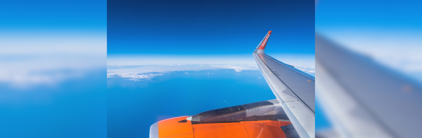The wing of an easyJet plane, as photographed from inside the plane.