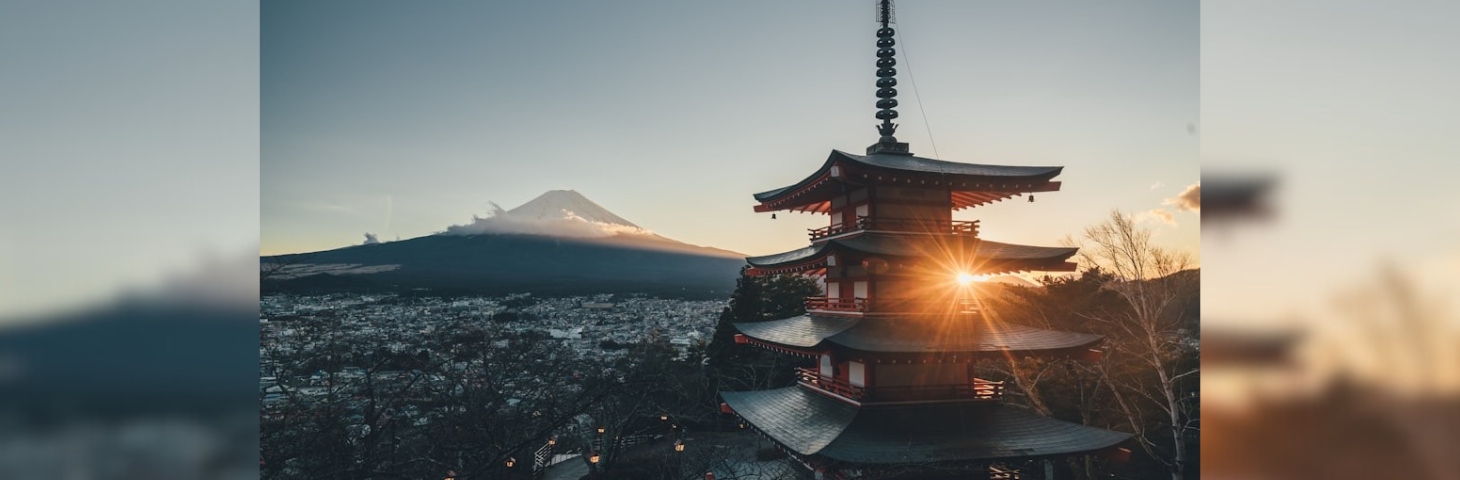 Mount Fuji and an ancient Japanese temple at sunset.