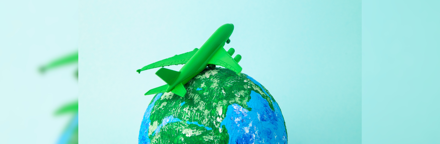 A green model plane sat on top of a globe.