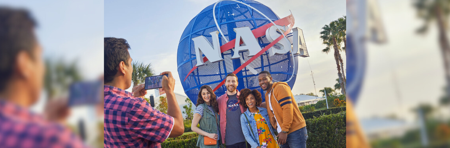 A group of friends posing for a photo with the NASA globe at Kennedy Space Center Visitor Complex.