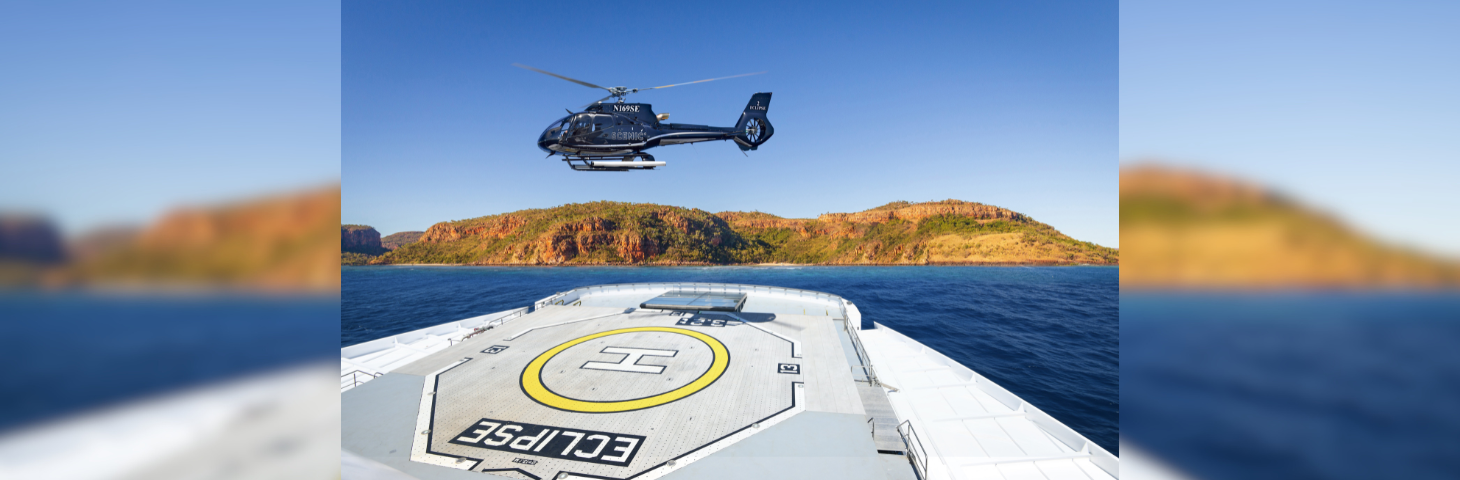 A helicopter landing on Scenic Eclipse's helipad.
