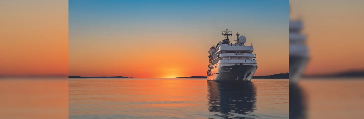 MS Caledonian at sea during sunset.