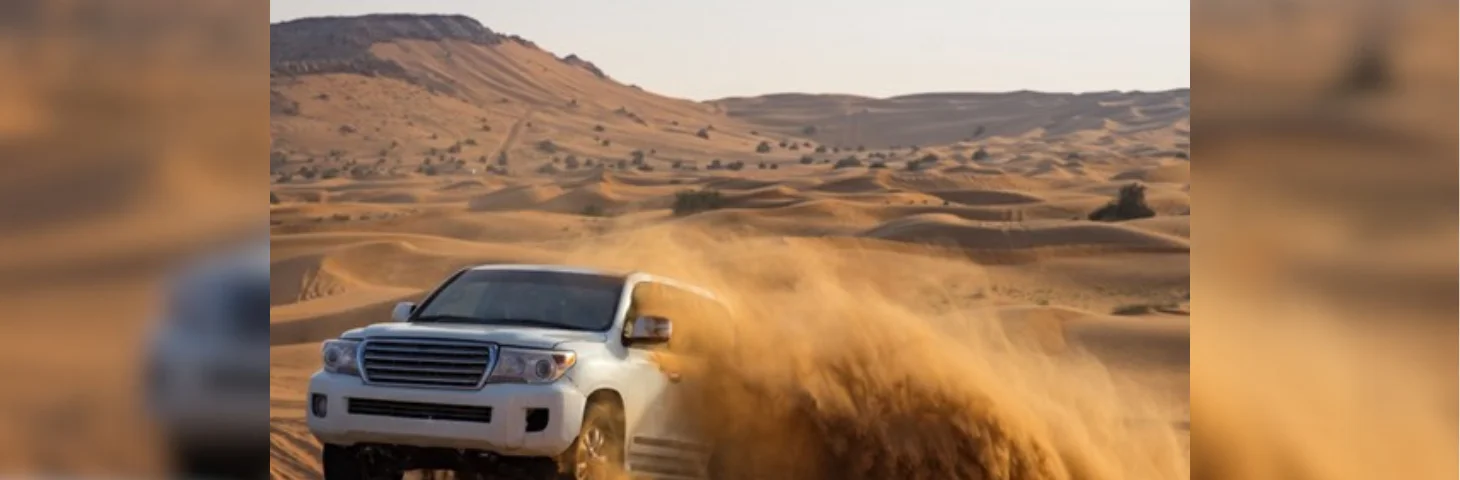 A Land Rover driving through the Dubai desert.