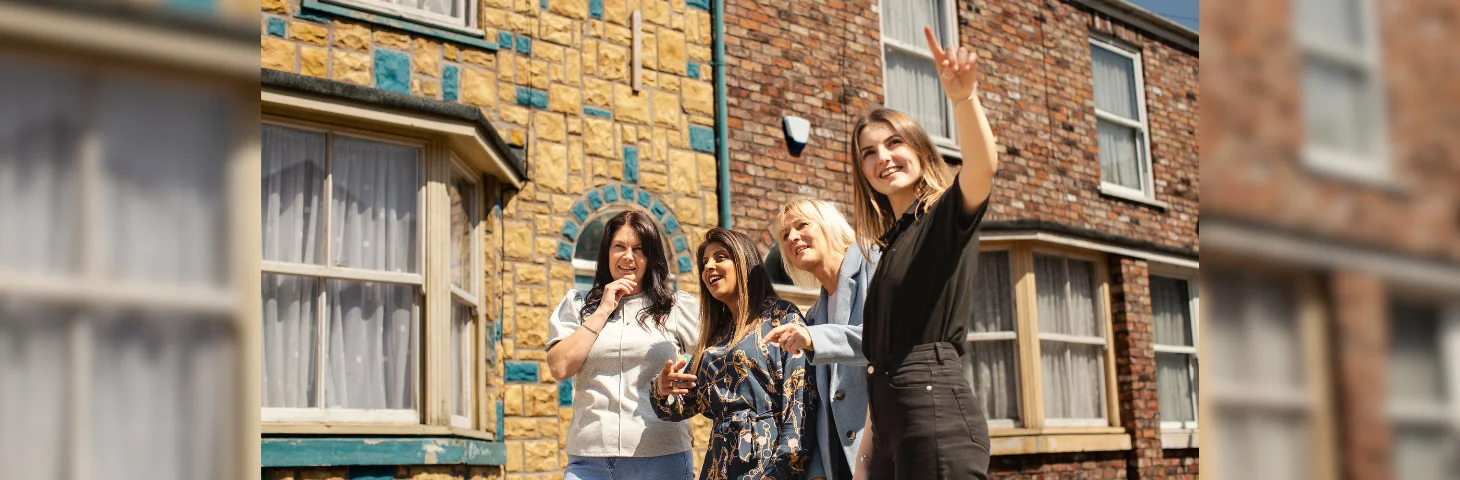 Three guests on a private tour of the Coronation Street set at The Coronation Street Experience.