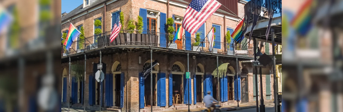 A man cycling through the French Quarter in New Orleans.