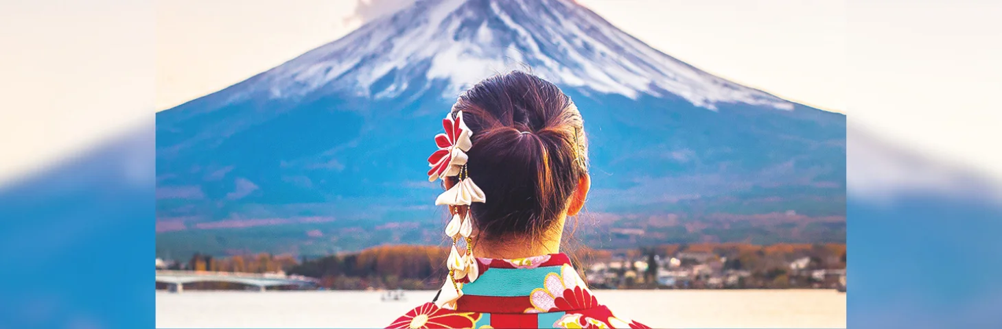 A person in traditional Japanese dress at Mount Fuji.