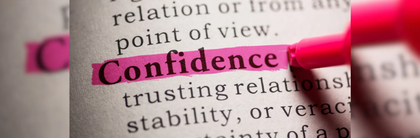 A pink highlighter highlighting the definition of 'Confidence' in a dictionary.