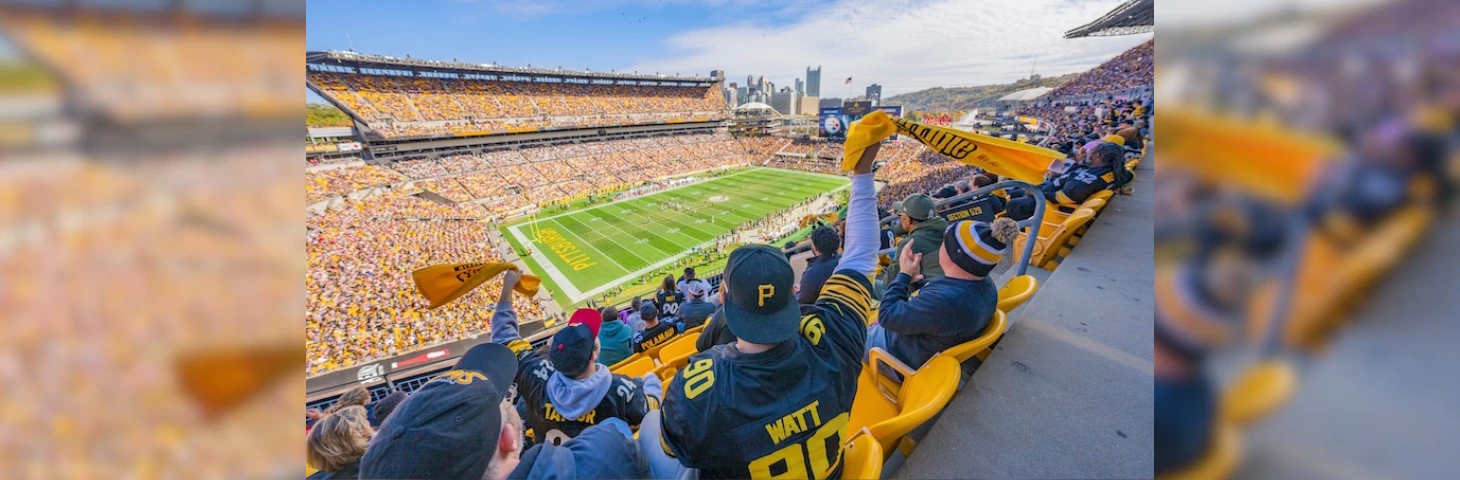 Image of Pittsburgh fans celebrating in the an american football stadium