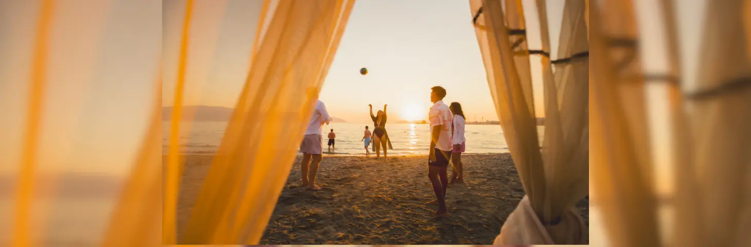 Image of a group of young adults playing on the beach in Albania.