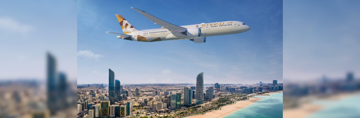 Image of an Etihad Boeing 787 flying over a city