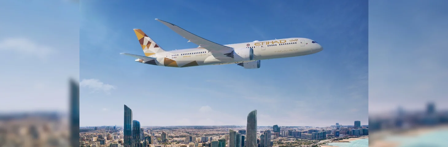 An Etihad Boeing 787 flying above Dubai. 