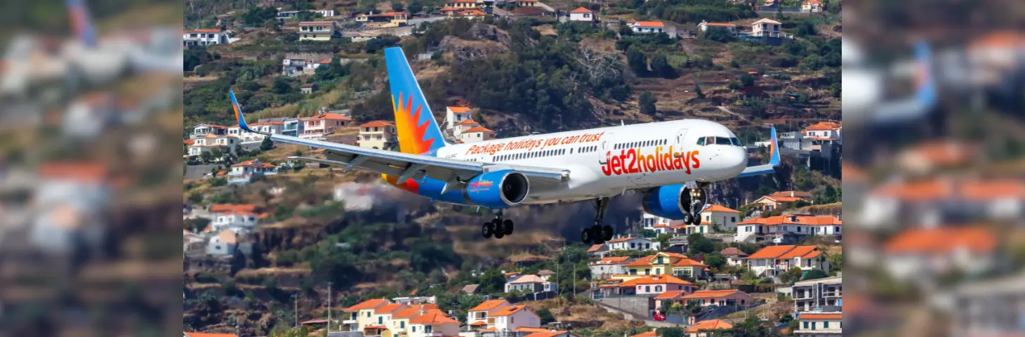 Image of a Jet2holidays plane flying over a city. 