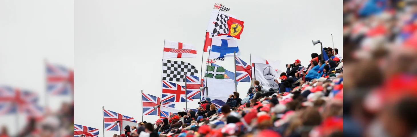 Several international flags waving from the stands at the Formula 1 Grand Prix.