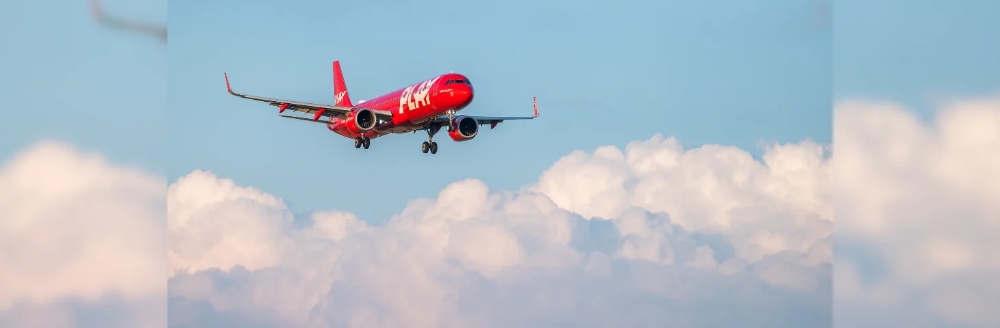 A PLAY Airbus aircraft in flight. 