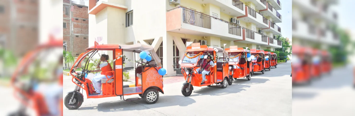 Female e-rickshaw drivers on Intrepid-branded e-rickshaws in Varanasi, India.