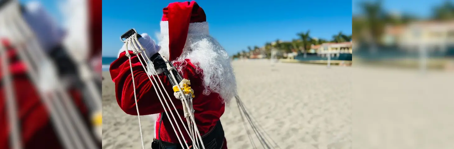 Image of Santa after landing on a beach with a parachute