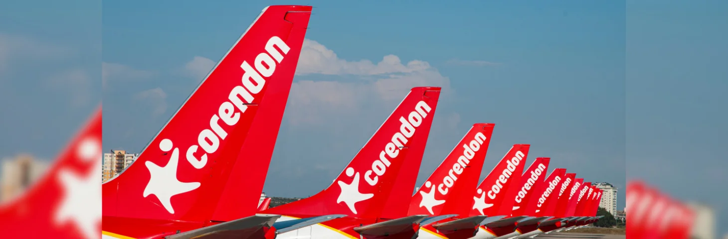 The tails of Corendon Airlines aircraft lined up on the runway.