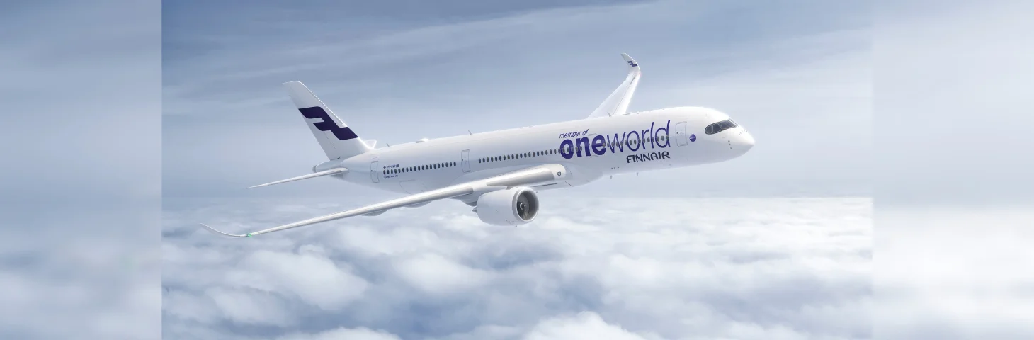 A Finnair Airbus A350 with the 'oneworld Alliance' logo emblazoned on the side in flight.