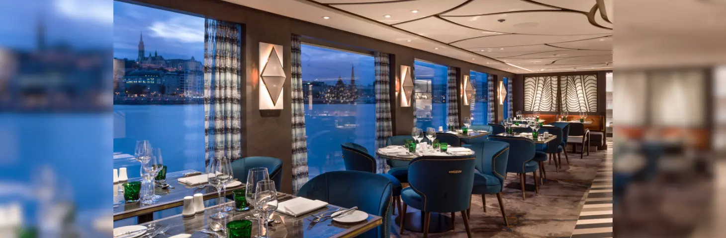 Image of the restaurant inside the SS Victoria ship against a city scape in the background