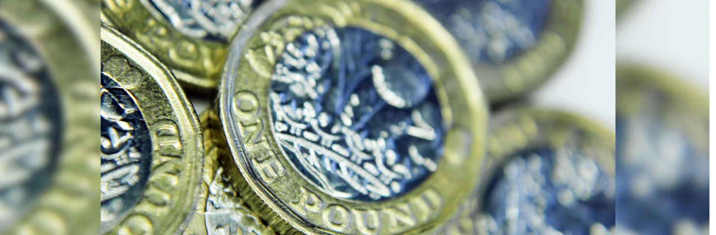 A pile of British £1 coins.