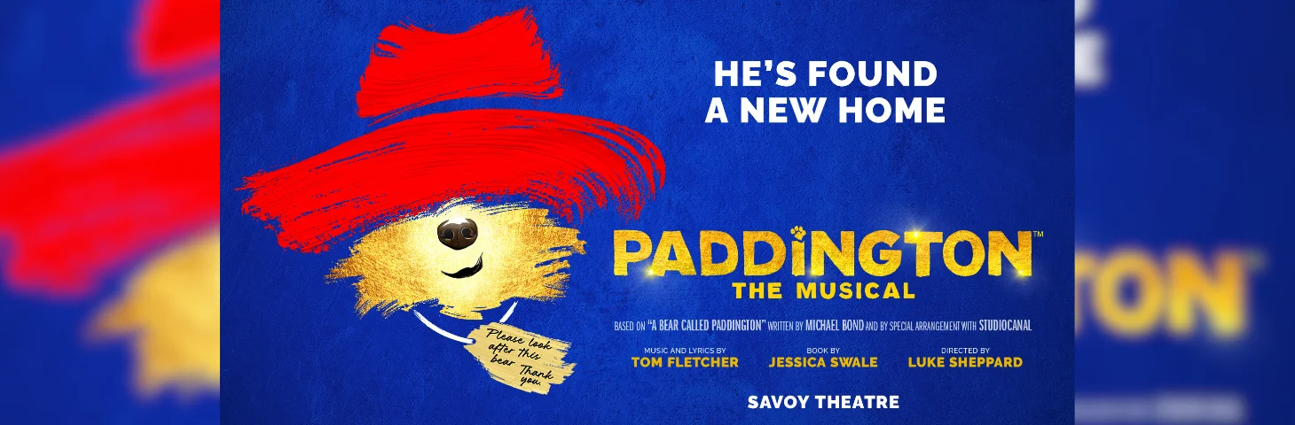 A promotional banner for the upcoming 'Paddington: The Musical' at the Savoy Theatre in London.