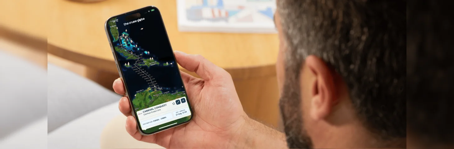 A person with dark hair and a beard tracking a cruise itinerary on The Cruise Globe mobile app.