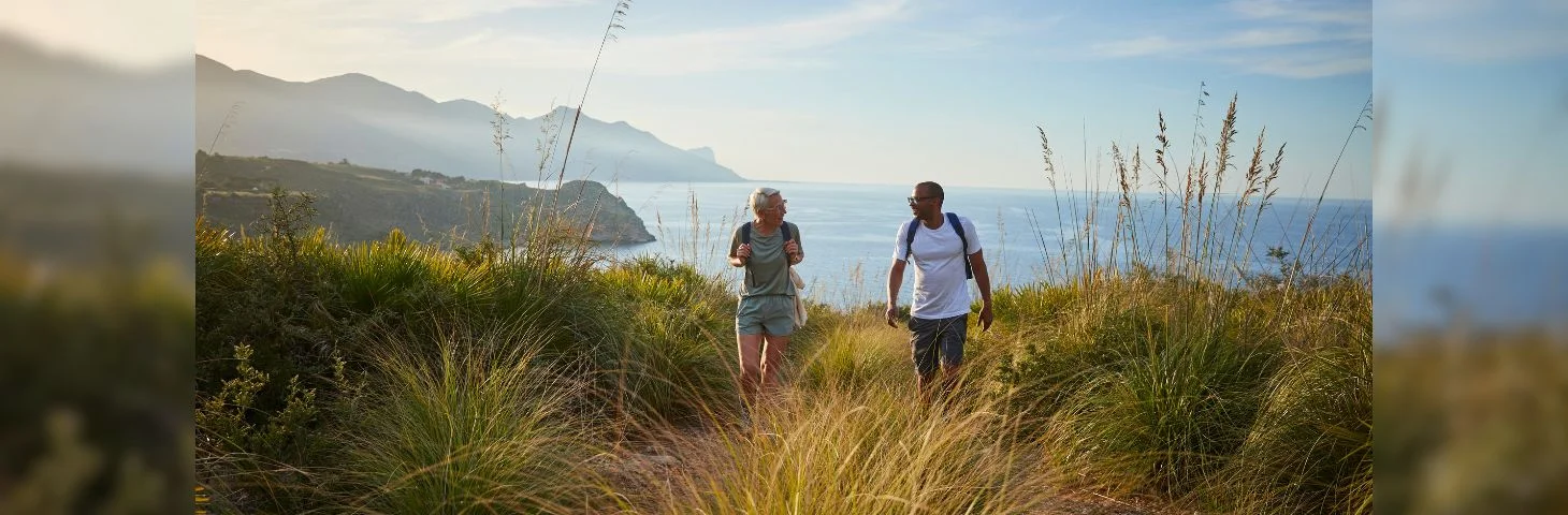 Two people hiking on a scenic coastal trail