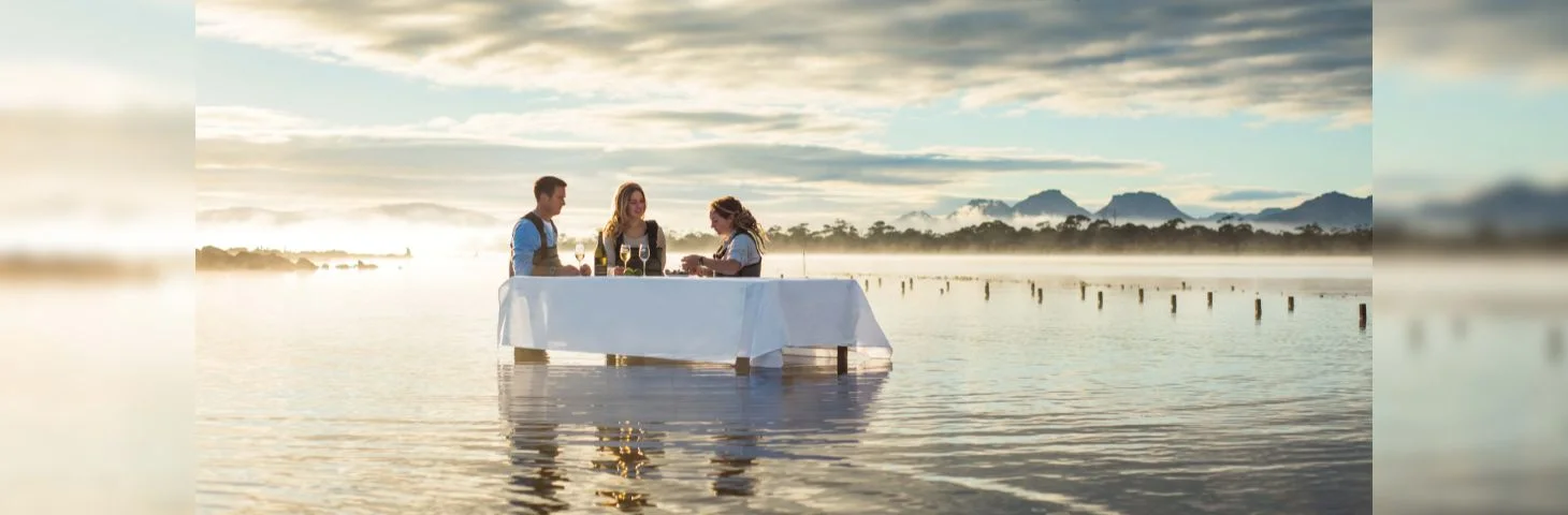 Three people at a marine farm experience at Tasmania's Saffire Freycinet all-inclusive resort.