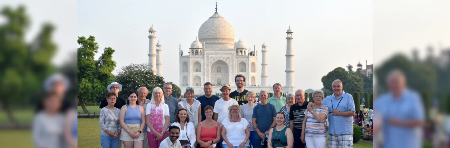 A group of Travelsphere customers and tour guides in front of the Taj Mahal in India.
