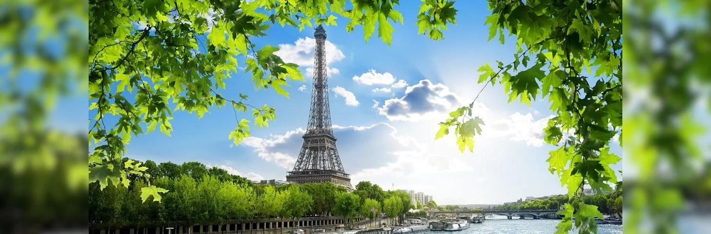 The Eiffel Tower, photographed from across the Seine River.