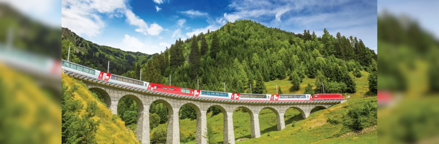 The Bernina Express train crossing the Landwasser Viaduct in the Swiss Alps. 