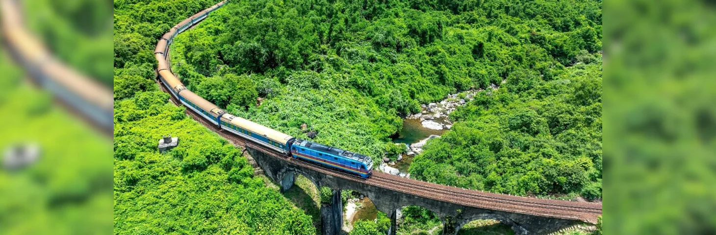 The Blue Jasmine train journeying across a viaduct in Thailand.