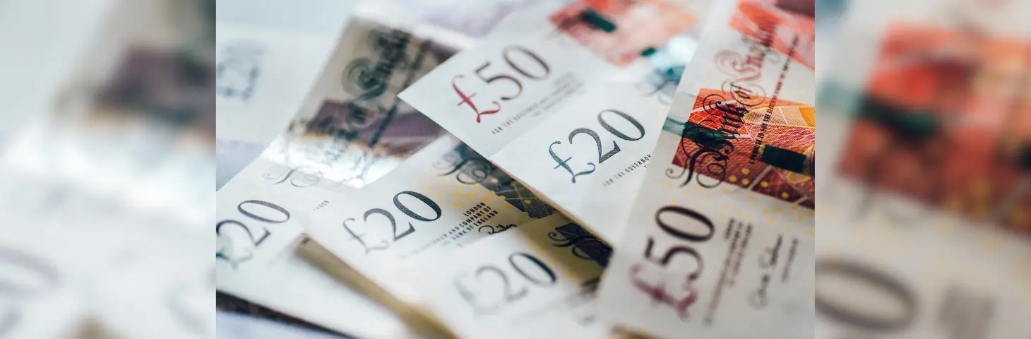 £20 and £50 notes spread across a table 