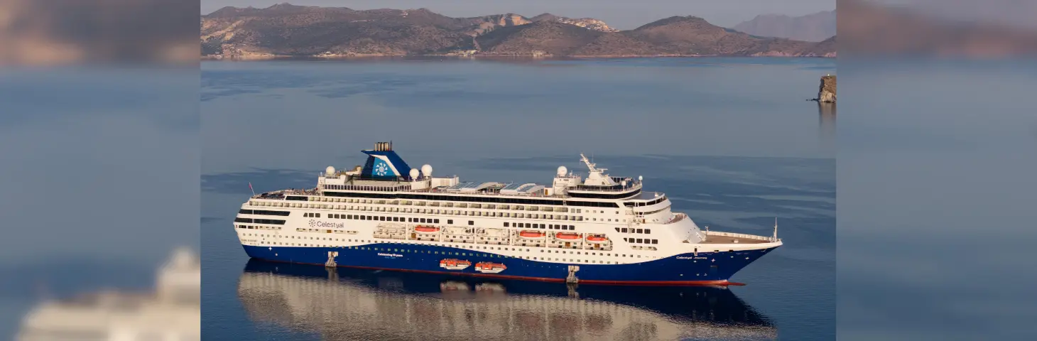 Celestyal cruise ship along the Gulf with hills in the background