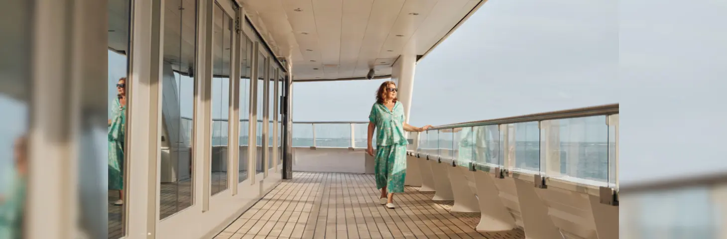 UK personality Jane McDonald walking along the deck of Scenic Eclipse, looking out to sea 