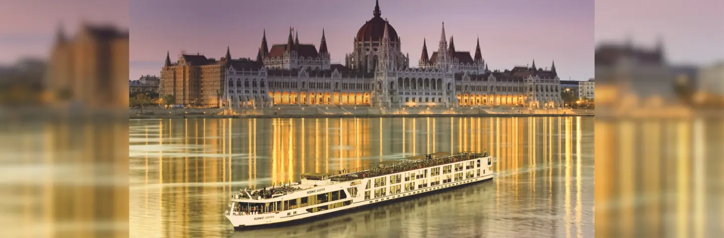 Scenic Jasper sailing in the Danube river at sunset past the Budapest Parliament Building in the background