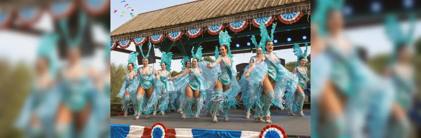 A carnival troupe performing on a stage for PortAdventura World