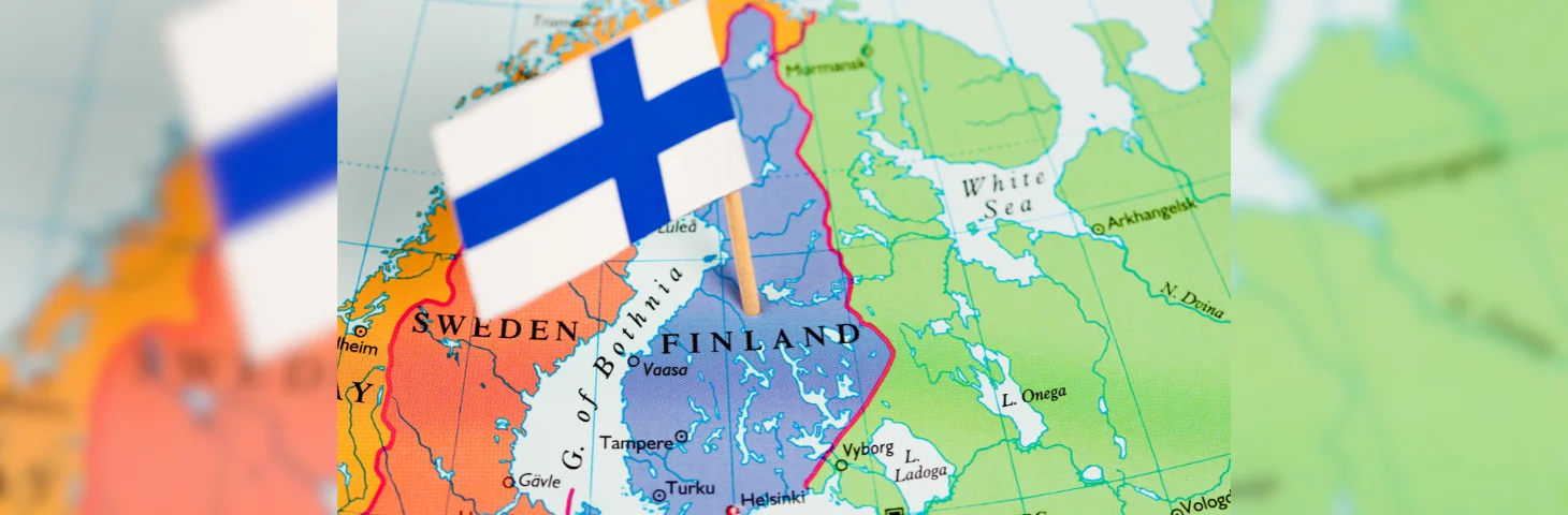 Map of Finland with flag poked into it