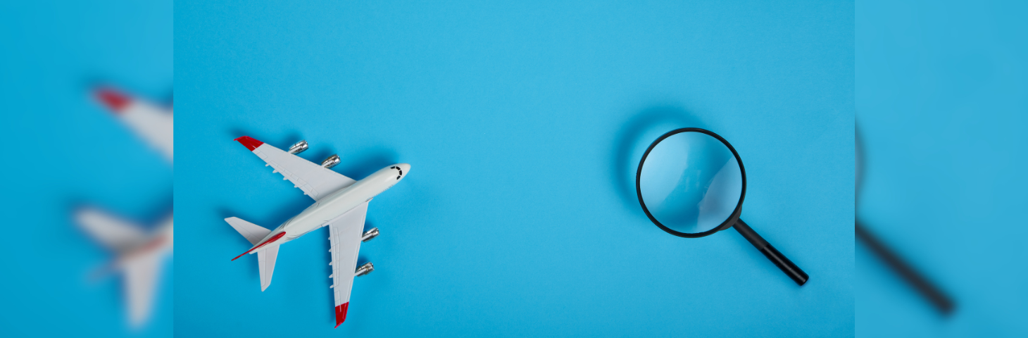 Graphic of a model aeroplane next to a magnifying glass.