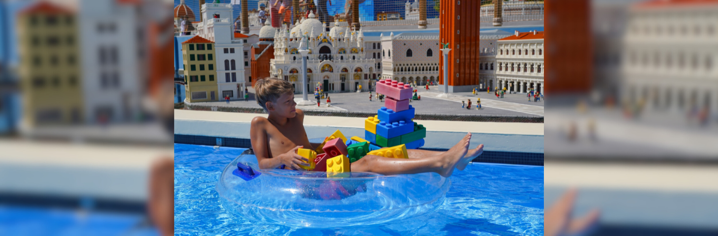 A boy sat in a floating ring at the LEGOLAND Water Park. 