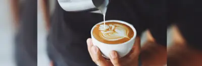 A barista making a latte.