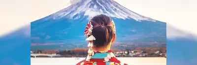 A person in traditional Japanese dress at Mount Fuji.