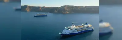 Image of Celestyal ships in Santorini bay. 