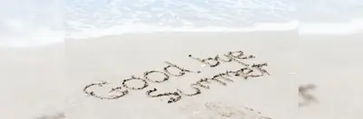 The words 'Goodbye Summer' drawn in the sand on a beach.