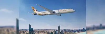 An Etihad Boeing 787 flying above Dubai. 